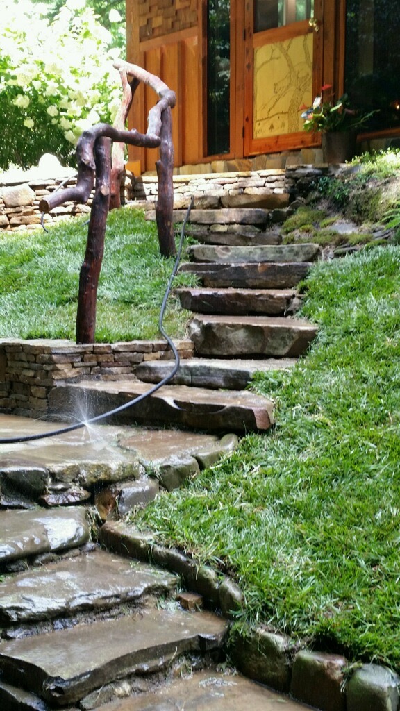 Stone steps with lading from parking area to house by Gonzalez Landscaping and Home Improvement